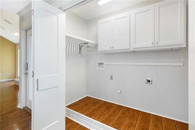 laundry area featuring hookup for a washing machine, hookup for an electric dryer, wood finished floors, visible vents, and cabinet space