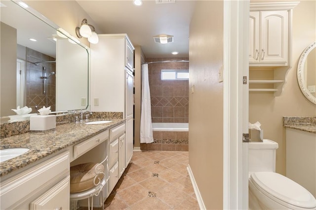 full bathroom featuring double vanity, visible vents, toilet, tile patterned flooring, and a sink