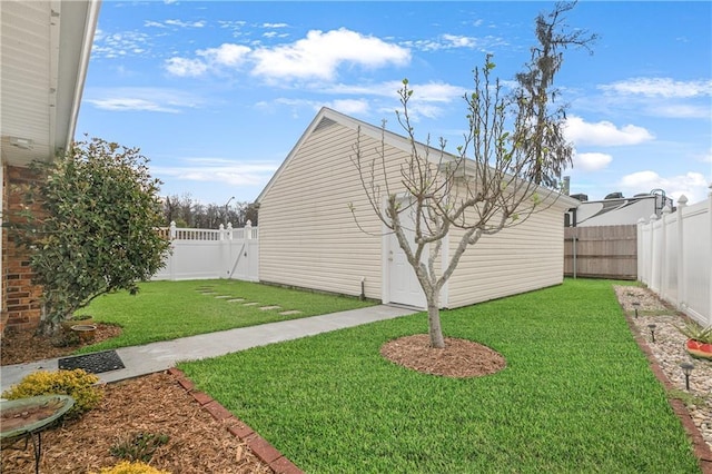 view of side of property with a fenced backyard, a lawn, and an outdoor structure