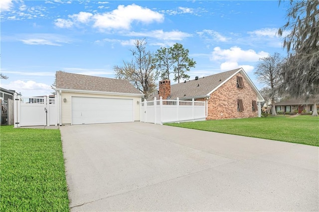 view of property exterior with a gate, fence, and a yard