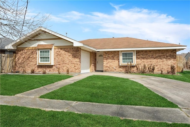 single story home with brick siding, concrete driveway, an attached garage, a front yard, and fence