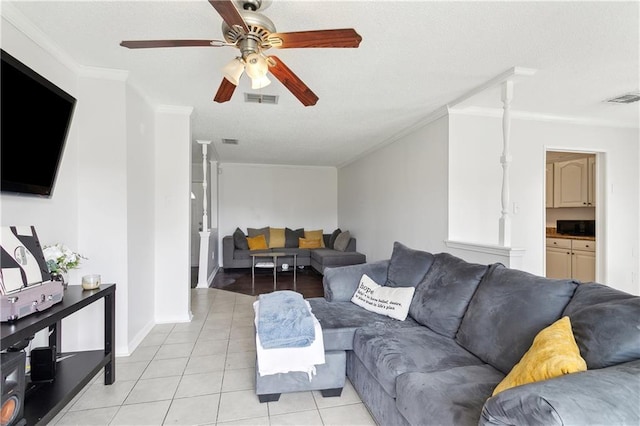 living room featuring ornamental molding, light tile patterned flooring, and visible vents