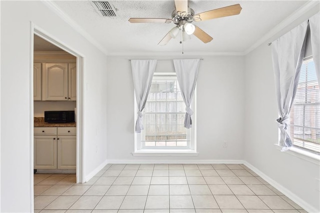 unfurnished room with light tile patterned floors, ceiling fan, visible vents, and crown molding