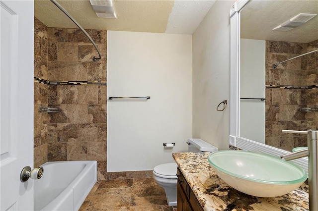 full bathroom with shower / washtub combination, toilet, a textured ceiling, vanity, and baseboards