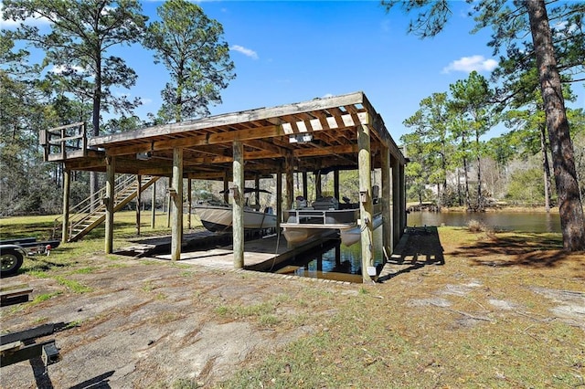 dock area featuring stairway, a water view, and boat lift