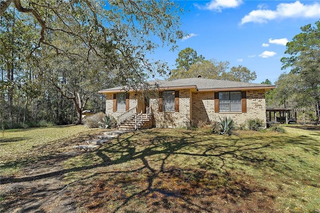 single story home featuring a front lawn and brick siding