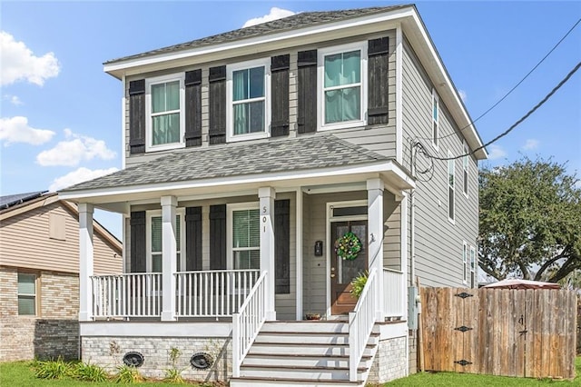 view of front of house featuring a porch and fence