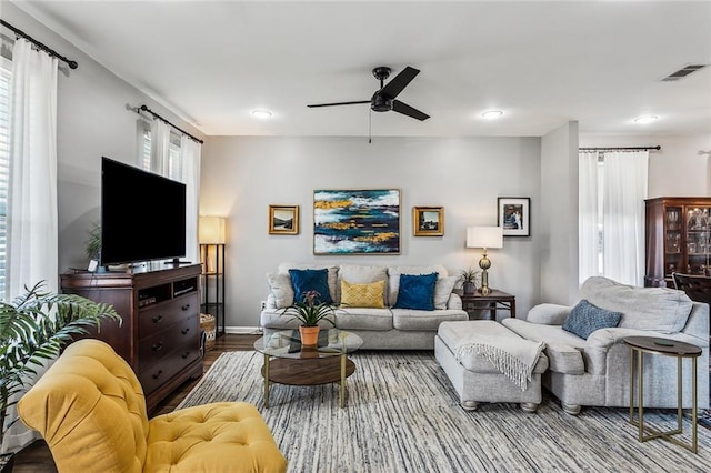 living room featuring baseboards, visible vents, ceiling fan, wood finished floors, and recessed lighting