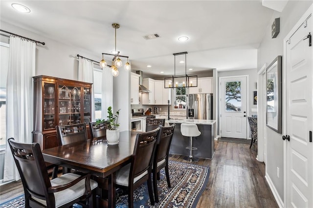 dining room featuring dark wood-style flooring, visible vents, and recessed lighting