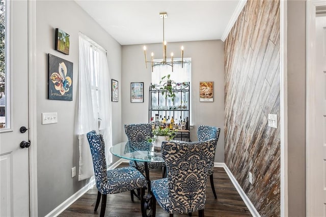 dining space featuring a notable chandelier, baseboards, and dark wood-type flooring