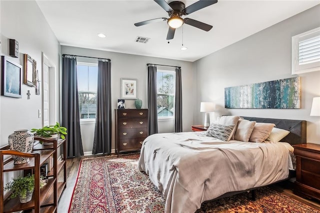 bedroom featuring a ceiling fan, recessed lighting, visible vents, and wood finished floors