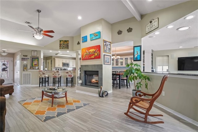 living room featuring visible vents, ceiling fan, high vaulted ceiling, beamed ceiling, and baseboards