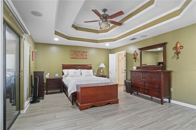 bedroom with visible vents, a raised ceiling, and ornamental molding