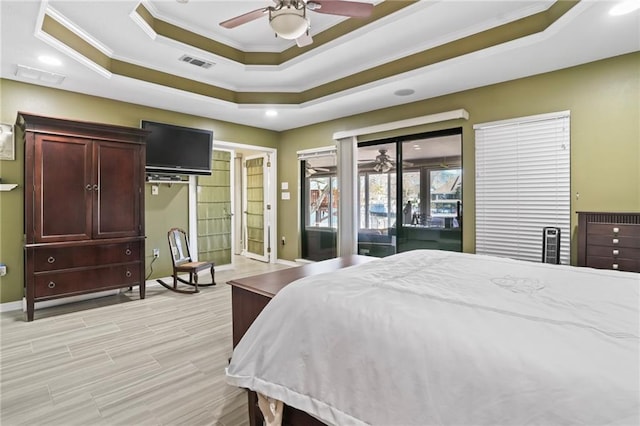 bedroom featuring visible vents, baseboards, access to exterior, a raised ceiling, and crown molding