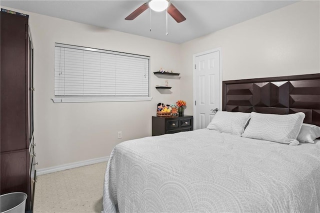 bedroom with ceiling fan and baseboards