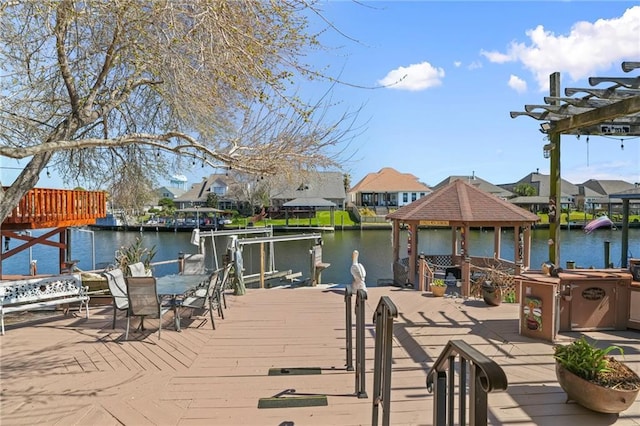 view of dock featuring a water view, a residential view, and a pergola