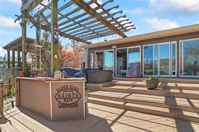 view of patio featuring a deck, exterior kitchen, area for grilling, and a pergola