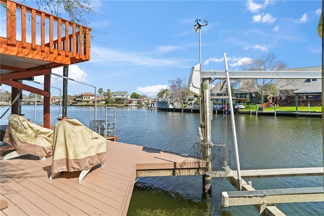 dock area with a water view and boat lift