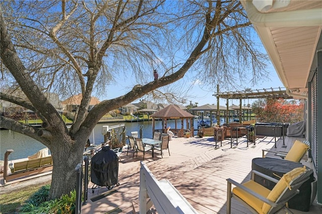 view of patio / terrace with a water view, a hot tub, a pergola, and a gazebo