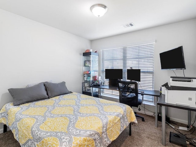 carpeted bedroom with baseboards and visible vents