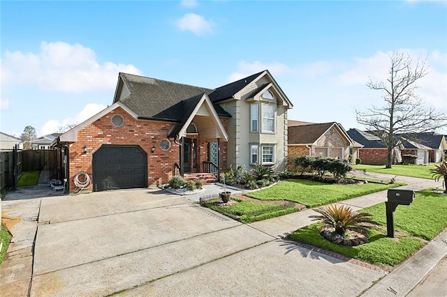 traditional home featuring brick siding, an attached garage, a front yard, fence, and driveway