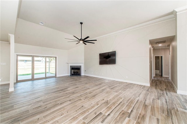 unfurnished living room featuring attic access, visible vents, a ceiling fan, a fireplace with flush hearth, and light wood-type flooring