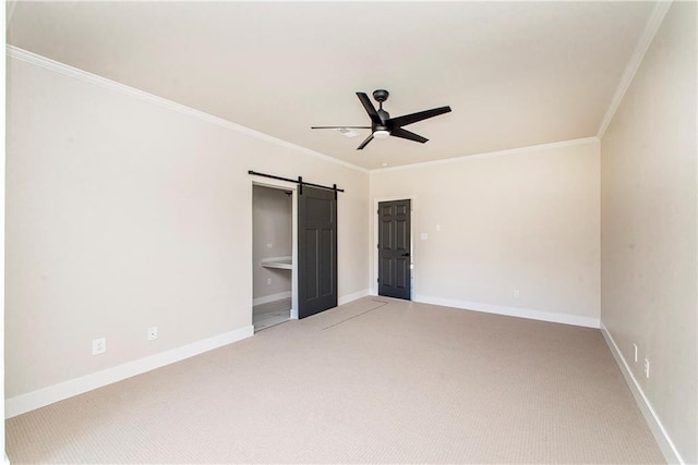 unfurnished bedroom with a barn door, light carpet, a ceiling fan, baseboards, and ornamental molding