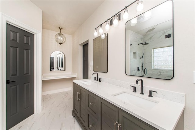 full bath with marble finish floor, a sink, a marble finish shower, and double vanity