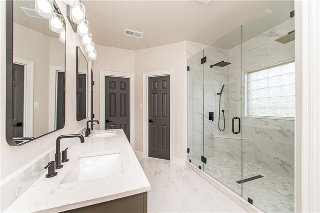 full bathroom with marble finish floor, a marble finish shower, and a sink