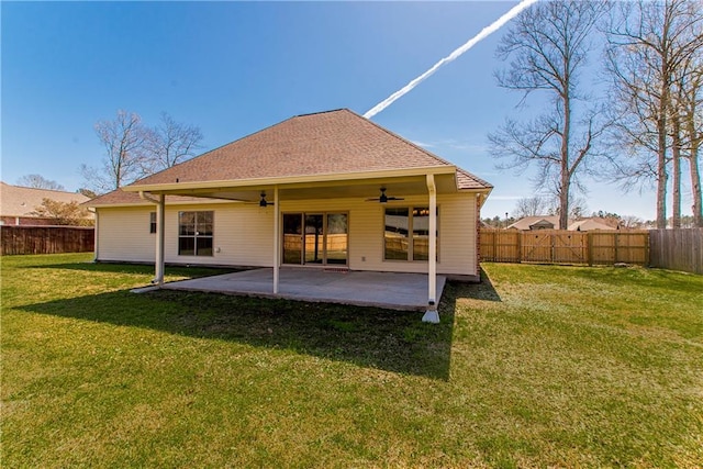 rear view of property with a lawn, a patio area, and a fenced backyard