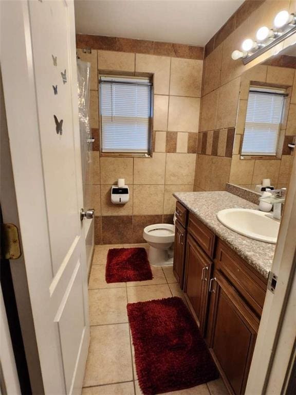 full bathroom with vanity, tile walls, and tile patterned floors