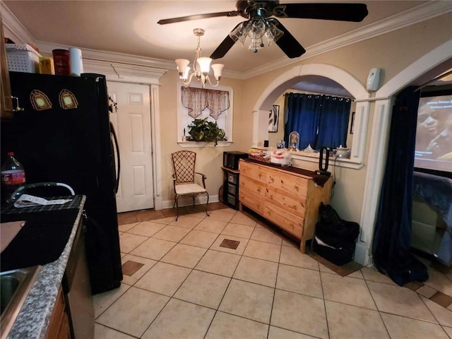 interior space with light tile patterned floors, ornamental molding, ceiling fan with notable chandelier, and freestanding refrigerator