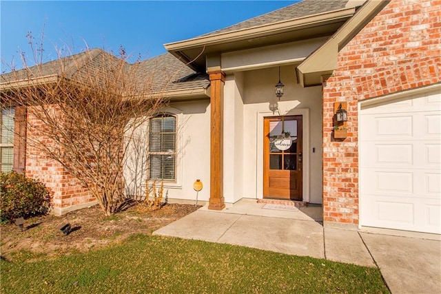 property entrance with an attached garage, a shingled roof, and brick siding