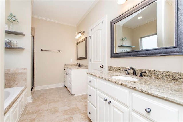 bathroom featuring a garden tub, two vanities, a sink, baseboards, and crown molding