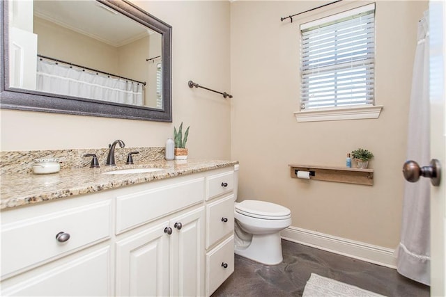 bathroom featuring toilet, crown molding, vanity, and baseboards