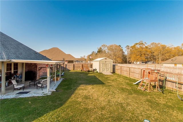 view of yard featuring an outbuilding, a fenced backyard, a patio, and a shed