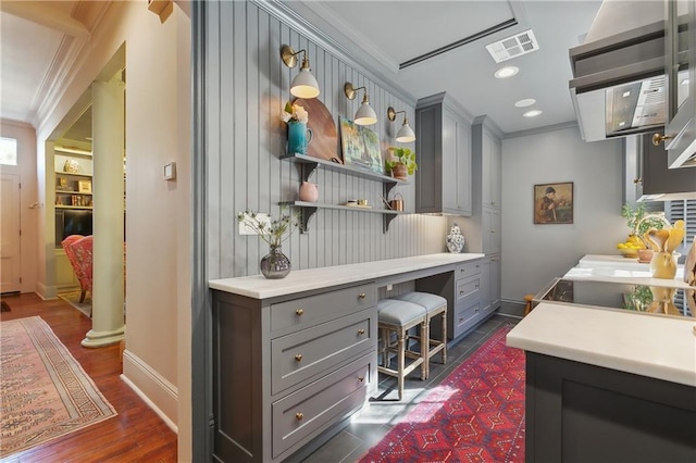 kitchen with light countertops, open shelves, crown molding, and gray cabinetry