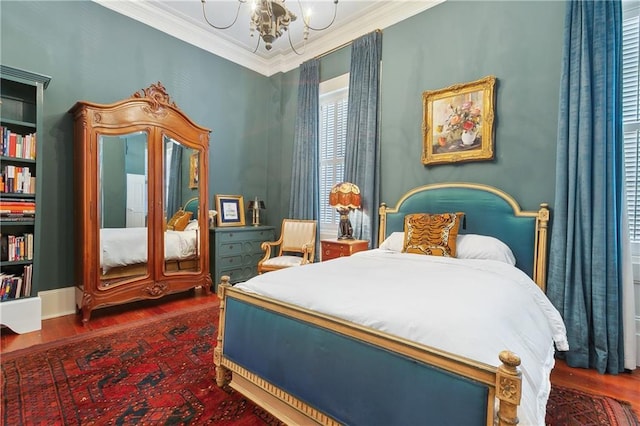 bedroom with a notable chandelier, dark wood-type flooring, and crown molding