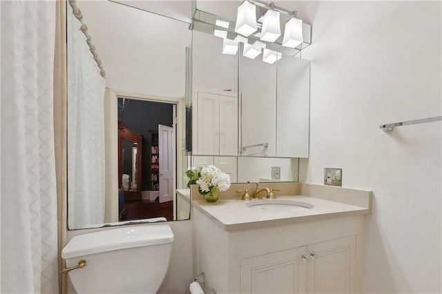 bathroom featuring a shower with shower curtain, vanity, and toilet