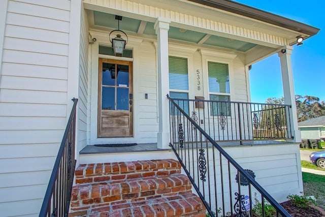 view of exterior entry with covered porch