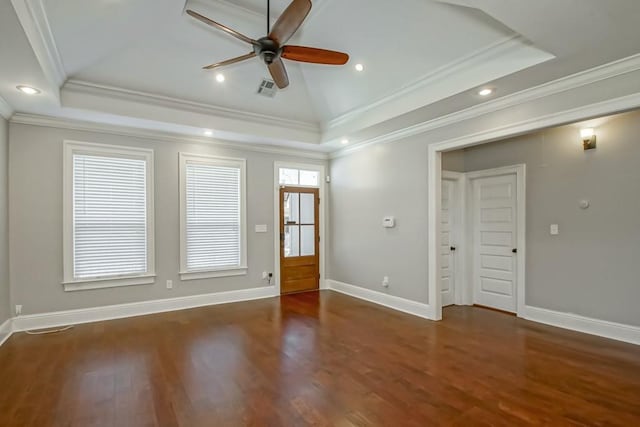 unfurnished room with ceiling fan, crown molding, a raised ceiling, and wood finished floors