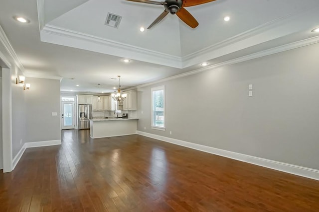 unfurnished living room with dark wood-style flooring, visible vents, crown molding, and baseboards