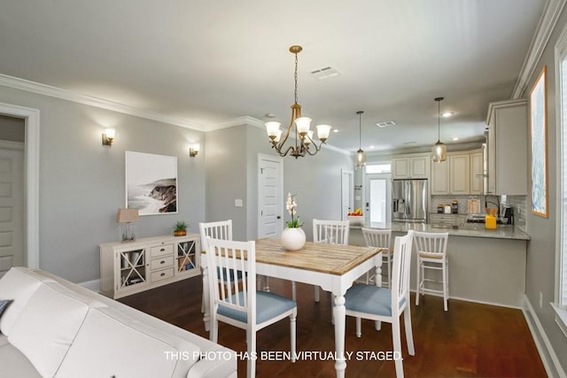 dining area with dark wood-type flooring, visible vents, and crown molding