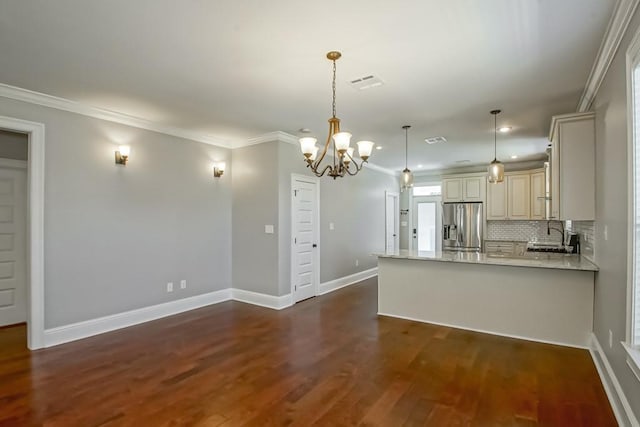 kitchen featuring crown molding, visible vents, cream cabinets, dark wood-type flooring, and stainless steel fridge with ice dispenser