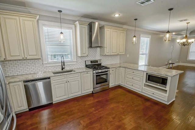 kitchen with stainless steel appliances, visible vents, a sink, a peninsula, and wall chimney exhaust hood