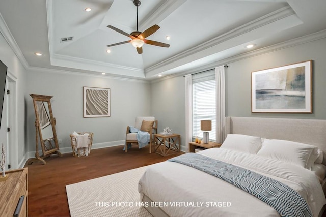 bedroom with a tray ceiling, recessed lighting, visible vents, ornamental molding, and baseboards