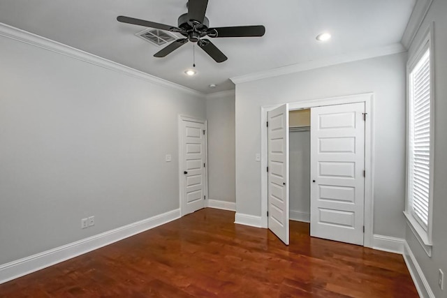 unfurnished bedroom with ornamental molding, baseboards, and wood finished floors