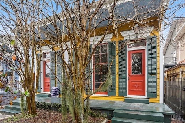 entrance to property featuring fence