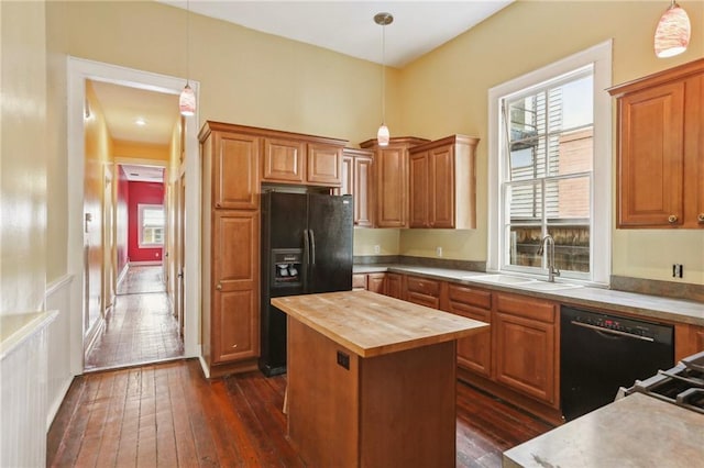 kitchen featuring dark wood-style flooring, a wealth of natural light, a sink, wood counters, and black appliances