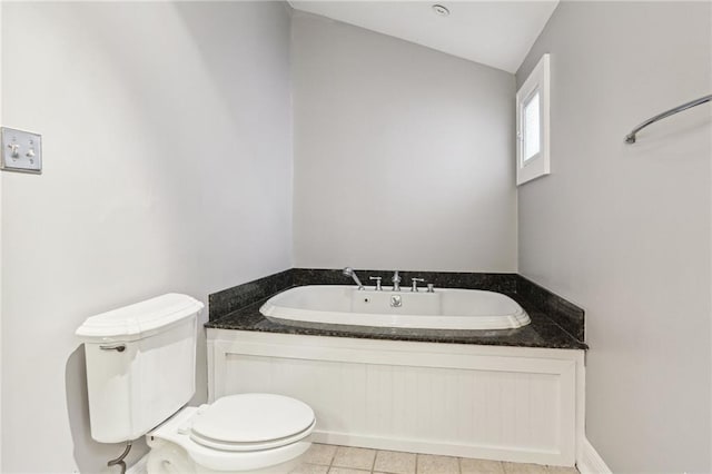 full bathroom with toilet, a garden tub, tile patterned flooring, and lofted ceiling